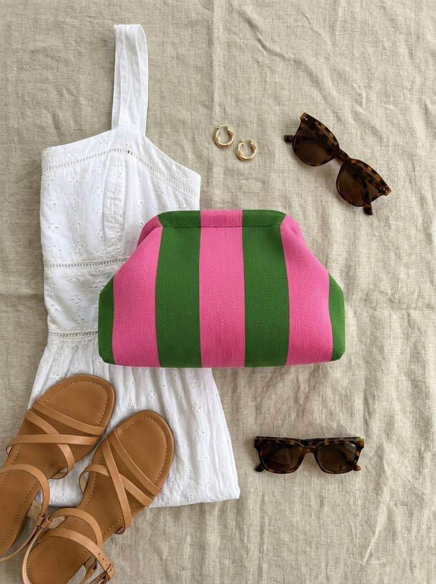 Flat-lay of the striped knit clutch with a white dress and sandals